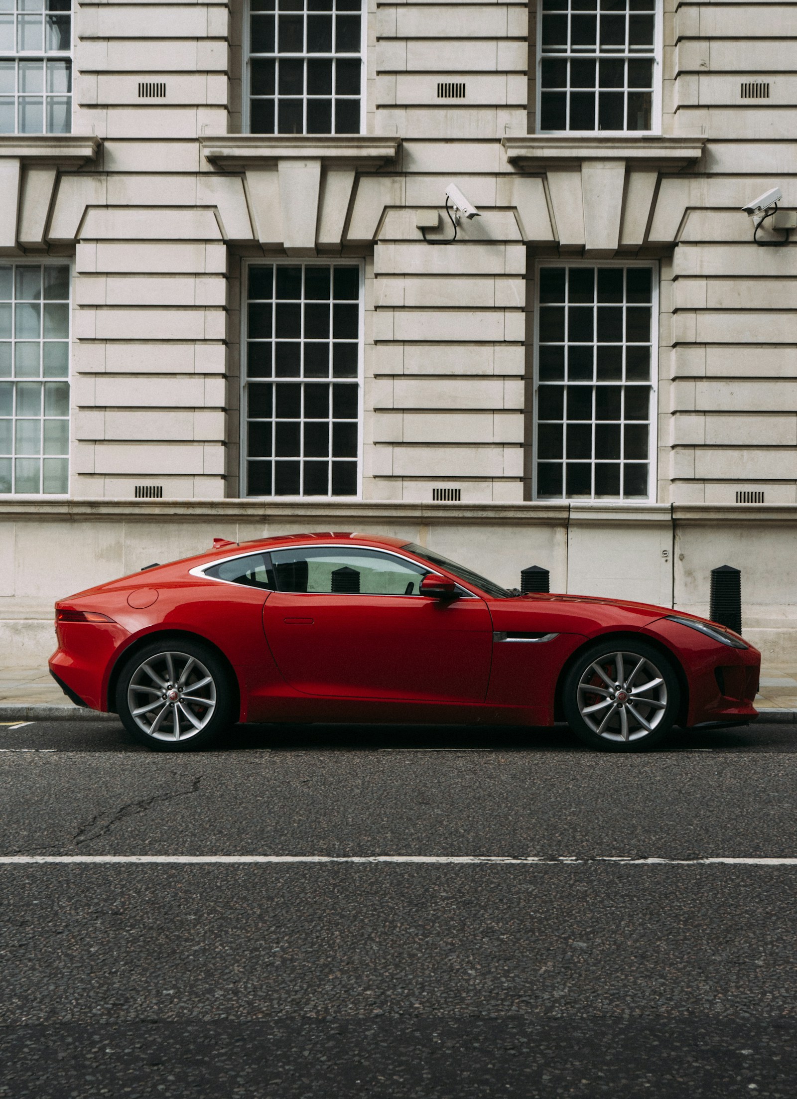 Red sports car parked on a city street